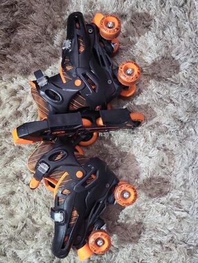 Black Roller Skates with Bright Orange Wheels And Blades